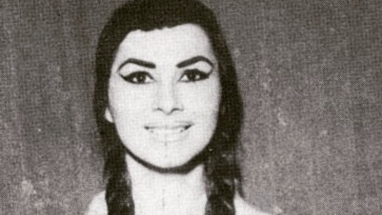 Vintage photograph of April Ashley with bold eyeliner and twin braids.