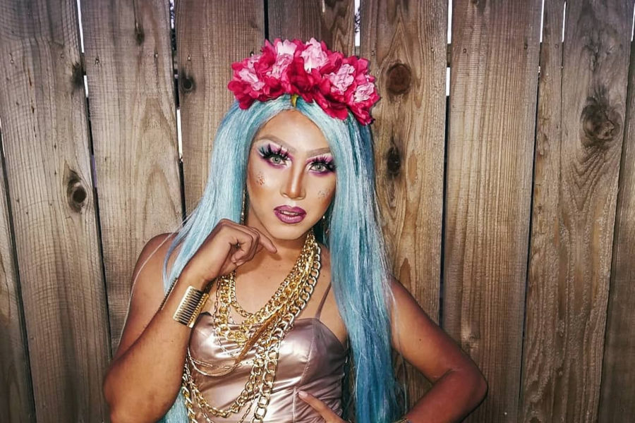 Drag queen Weendy Diamond at Alibi Bar in Fresno, wearing a rose-gold dress, gold chains, and electric blue hair.