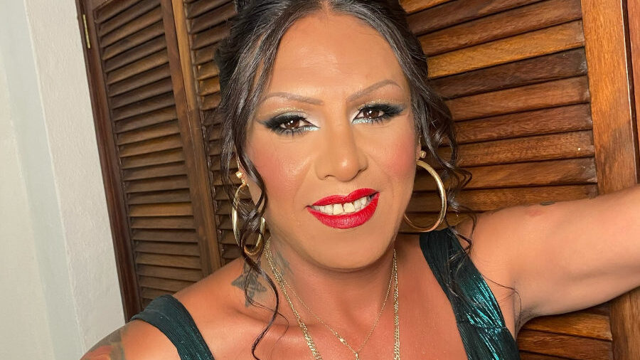 Close-up of Kenya Cuevas with styled hair, makeup, and jewelry at a Pride event in Mexico.