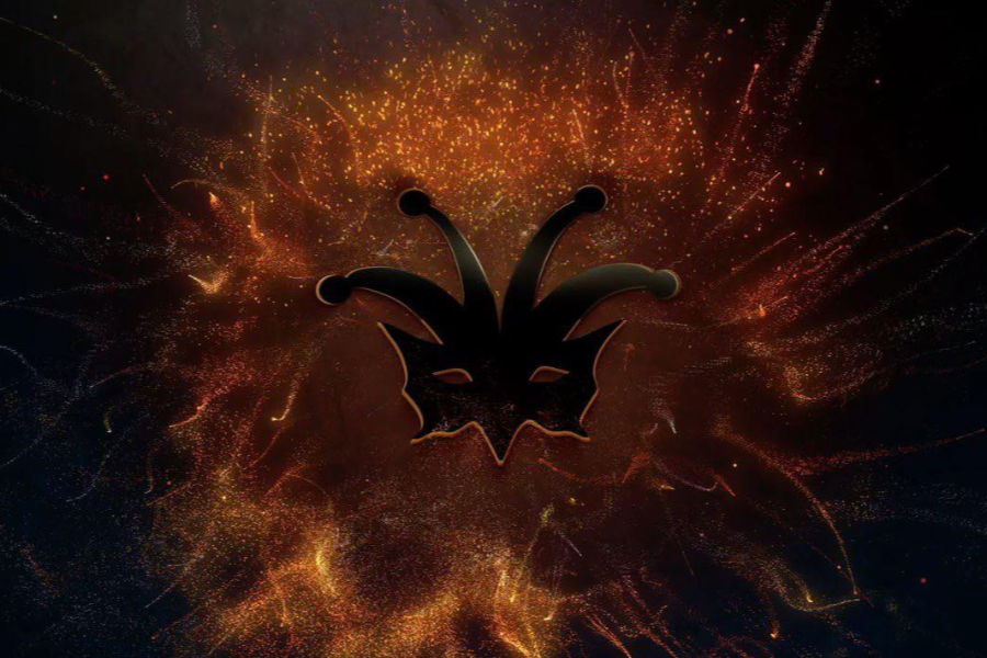 Graphic of a theatrical mask with jester horns, glowing in fiery red and orange particles, Teatrino by Theatron logo.